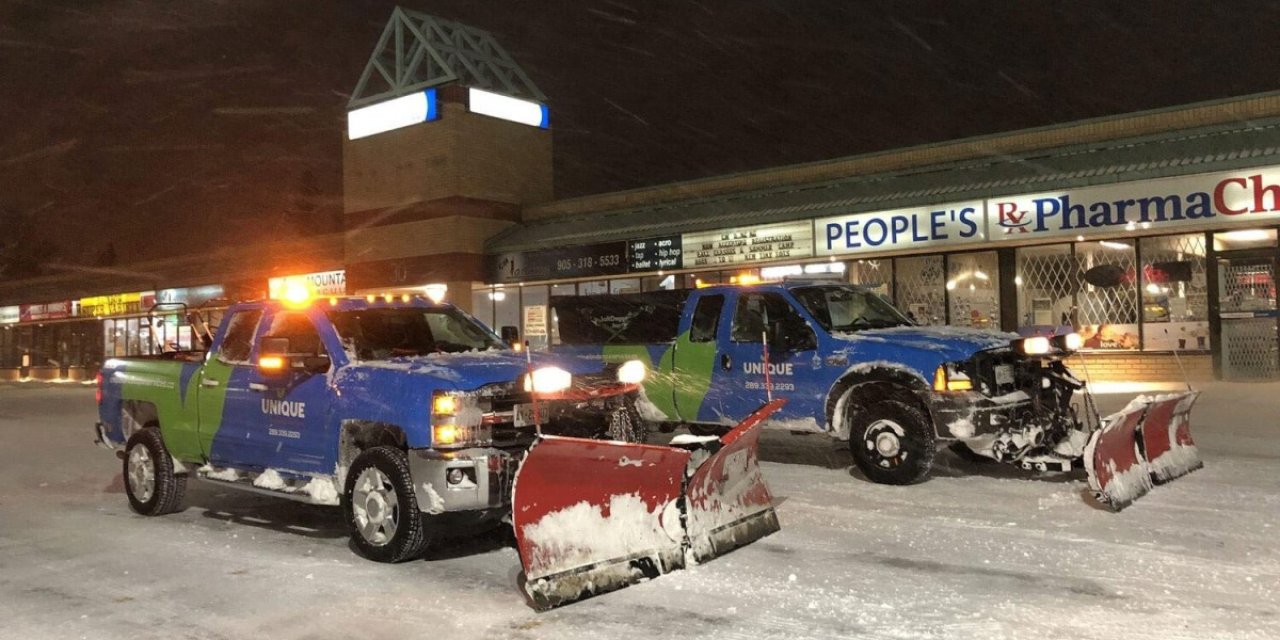 snow plow trucks in storm