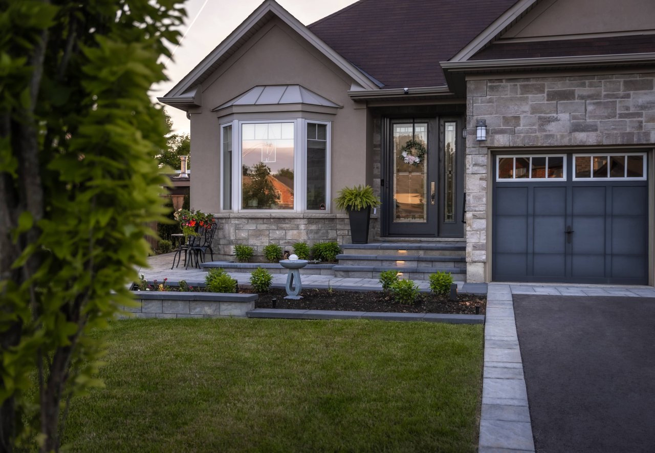 Front entrance landscape with a garden and walkway.