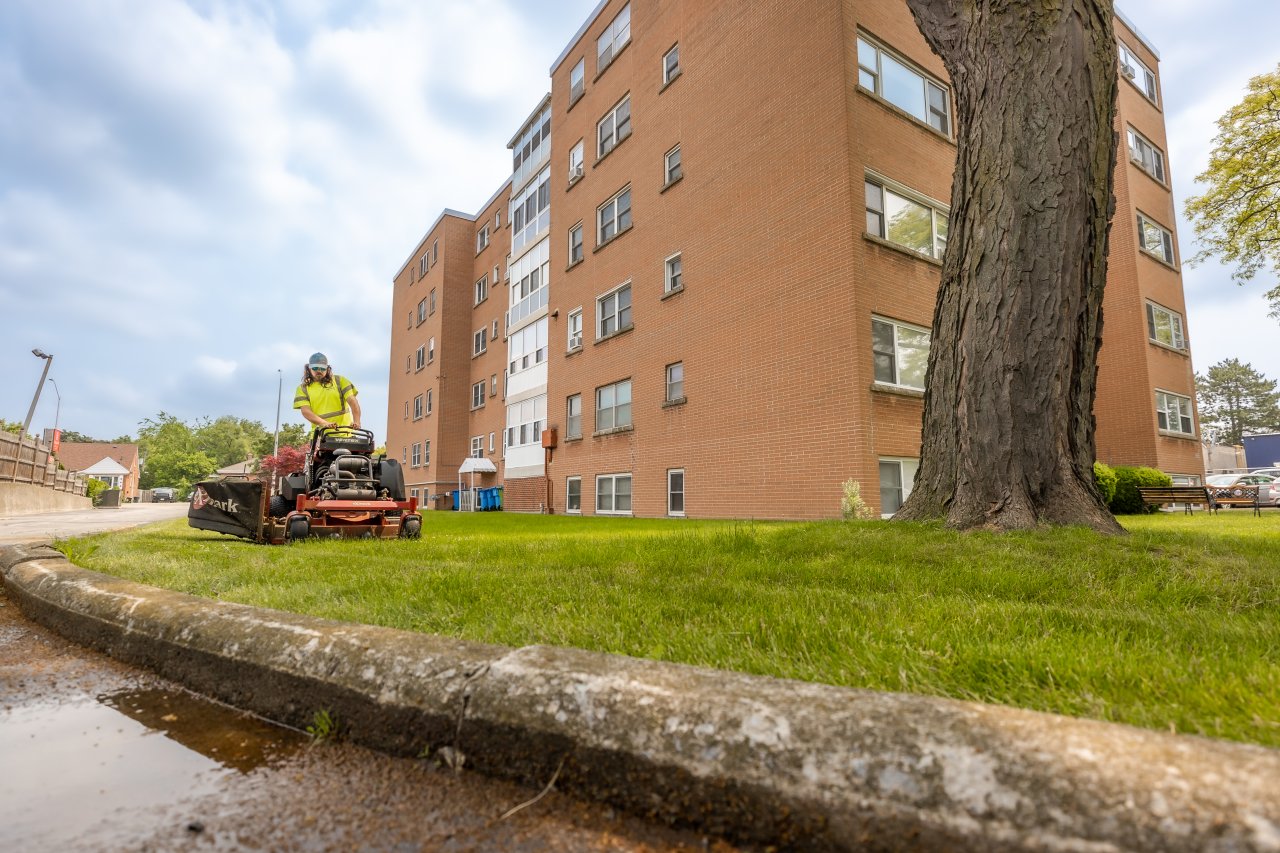 A crew member mowing the lawn
