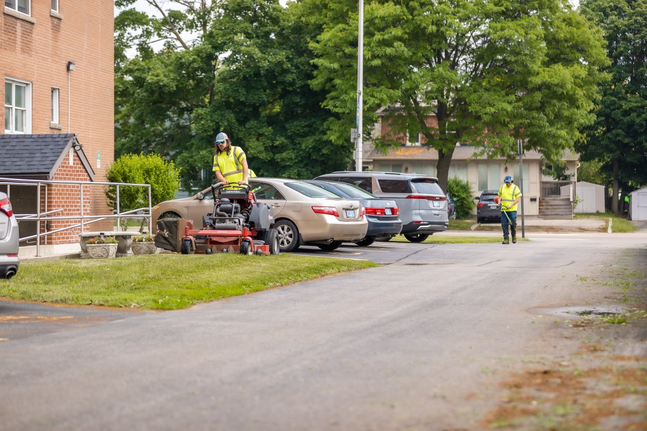 A crew member mowing the lawn