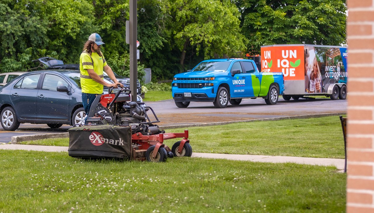 A crew member mowing the lawn