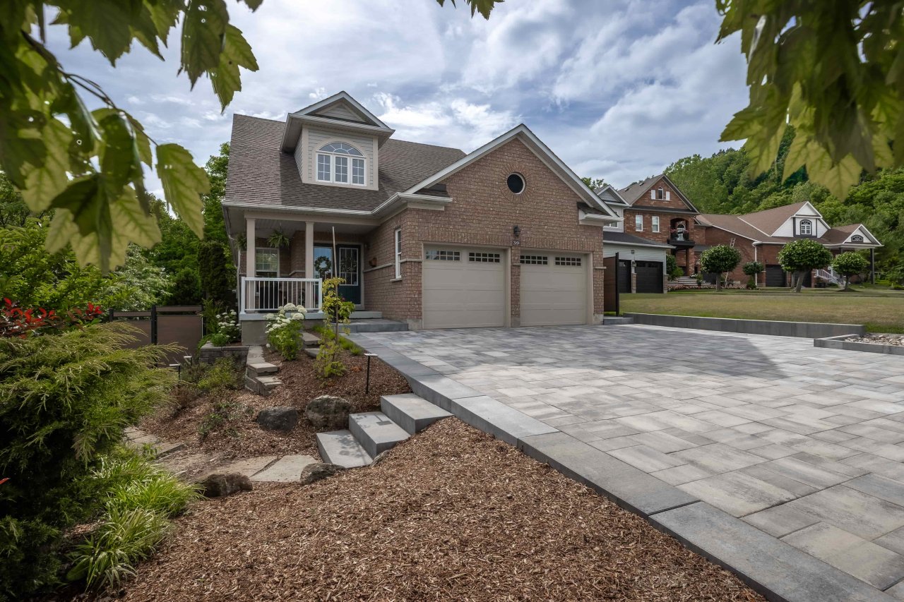 Front entrance landscape with an interlock driveway and walkway.