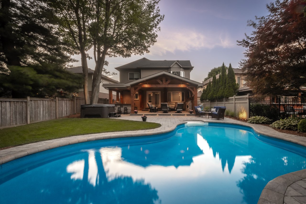 Back yard resort with pool and lounge seating.