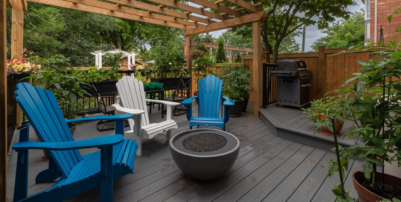 Residential backyard patio with fire table and large pergola